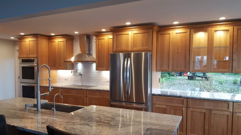 Kitchen Design on Candlewood Lake, a transitional Kitchen style with white Cherry wood Shaker doors. Incorporating a fixed glass window backsplash.